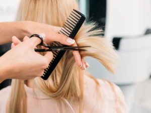 Blonde woman getting a haircut