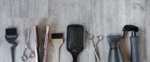 Hair salon tools on wooden background - Salon Bambino