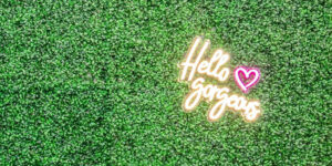 Salon Bambino moss wall with Hello Gorgeous neon light